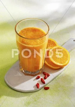 A sunshine smoothie made with bananas, pineapple, mango, oranges and goji Stock Photos