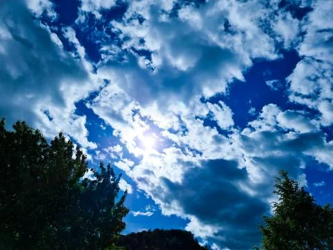 Sunshine through Clouds in the Blue Sky Sunlight Stock Photos