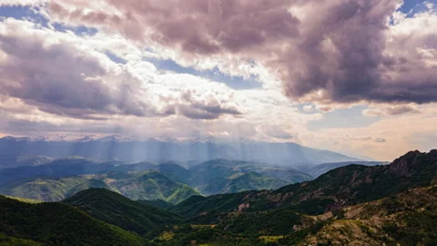 Sunshine Through Clouds Over The Mountains Time Lapse Stock Footage