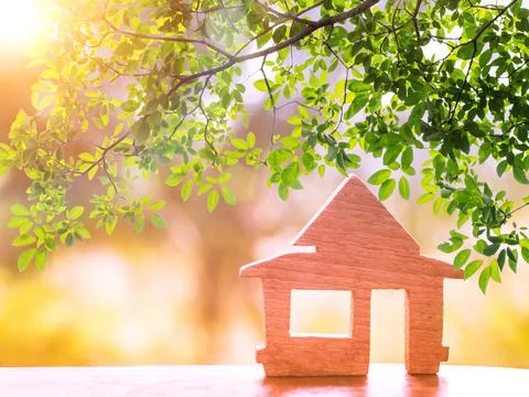 Sunshine through wooden House model there space. home, housing and real estat Stock Photos