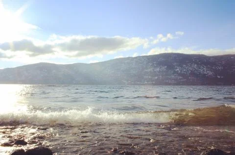 Sunshine, waves and bright sky at the lake Stock Photos