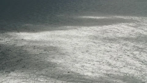 Sunspots and cloud shadows on the sea waves. Long shot taken with a tripod Stock Footage 220999518