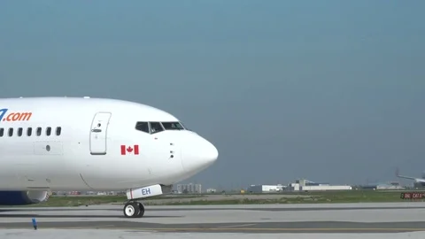 Sunwing EH Waits for another Plane to Take Off Stock Footage 76418960