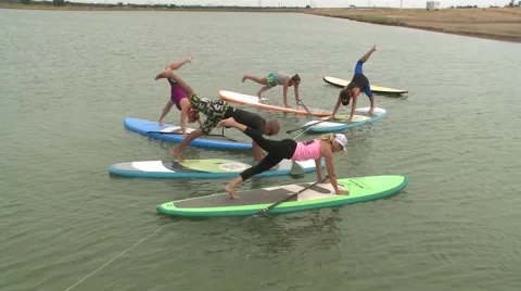 SUP STAND UP PADDLE BOARDING WORKOUT WITH UNIDENTIFIABLE PEOPLE HD 1080 Stock Footage 46266636