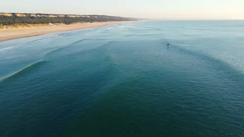 SUP Stand Up Paddle Surfer in a Sunset at Costa da Caparica beach, Portugal Stock Footage 146101813