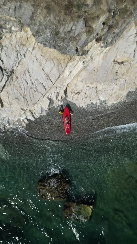 SUP surfer guy with a board and paddle on the seashore on a beautiful view of Stock Footage 252061503