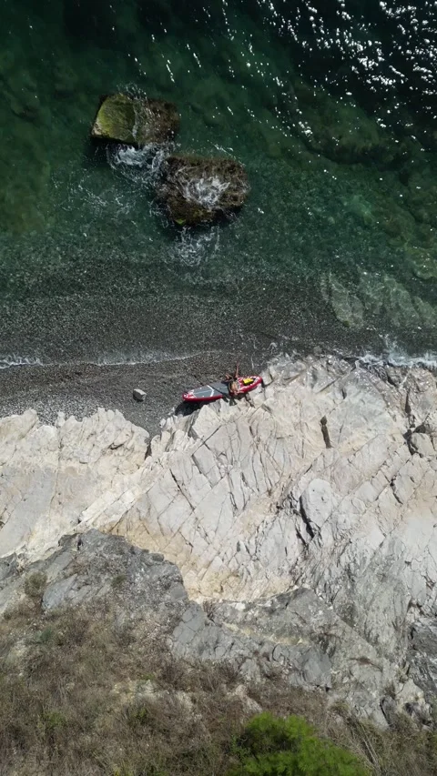 SUP surfer guy with a board and paddle on the seashore on a beautiful view of Stock Footage 252064804