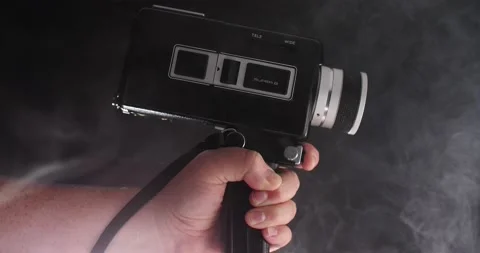 Super 8 film camera ready to make a movie with smoke rising filming Stock Footage 205535797