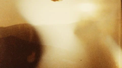 Super 8 frame authentic film scan with sprocket hole and dynamic sun lens flare. Stock Footage 142762886