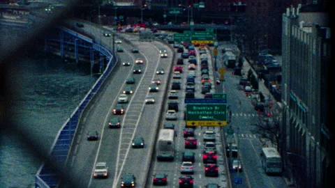Super 8 highway shot through fence exit 2 brooklyn bridge and nyc cityscape Stock Footage 251212024
