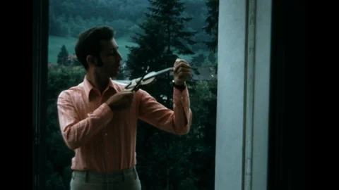 SUPER 8 - man playing a violin toy - 1971 Stock Footage 106729187