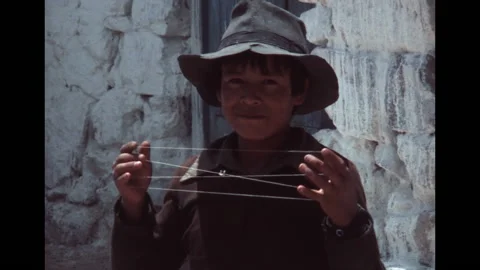 SUPER 8 - PERU - young peruvian boy doing String figure - Paracas - 1981 Video stock 160393273