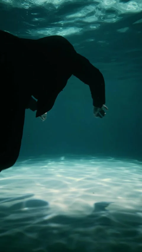 A super agent performs a mission underwater in a rich mans pool Stock Footage 315558573