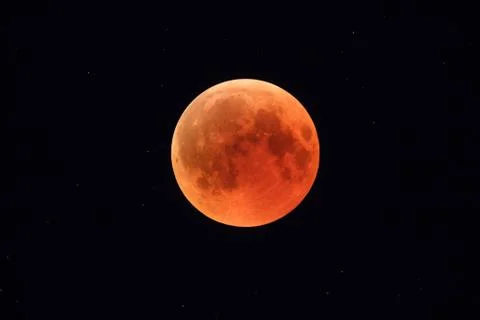 Super Bloody Moon, full eclipse phase against starry sky background Stock Photos