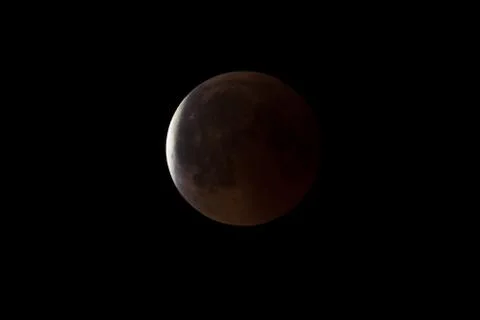 Super Bloody Moon, full eclipse end phase against black sky background, Earth Stock Photos