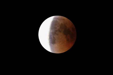 Super Bloody Moon, full eclipse end phase against black sky background, three Stock Photos
