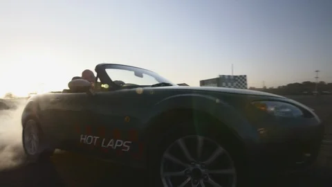 SUPER CAR performs DRIFT and lift a lot of SMOKE on AMAZING SUNSET 8 Stock Footage 127408644