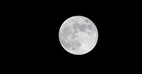 Super clear large moon in the night sky isolated on black bright Video stock 231747407