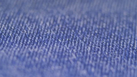 Super close-up blue denim fabrics details. textiles. concept sewing workshop. 4k Stock Footage 150368100