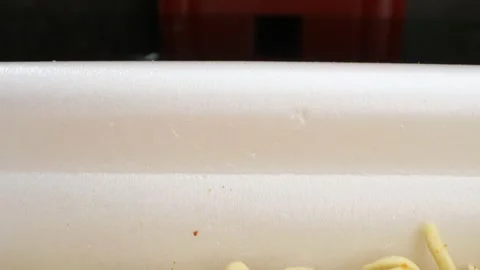 Super close up, boiling water is poured into instant noodles in a container Stock Footage 135294322