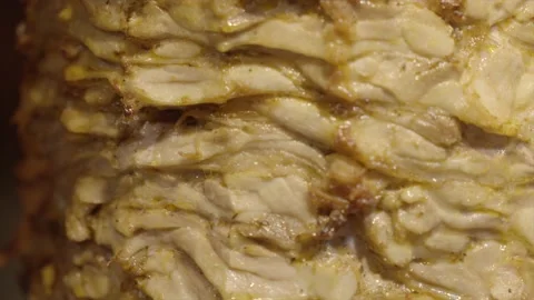 Super close up chicken shawarma rotating on spit Stock Footage 229984111