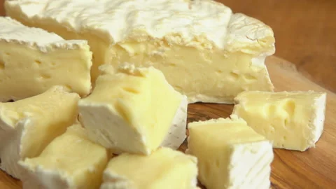 Super close-up of a delicious soft brie cheese cut into the cubes Stock Footage 136694806