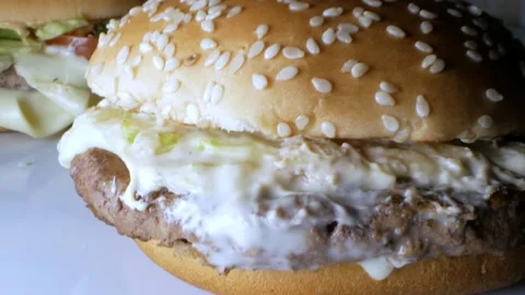 Super close-up, detailed. hamburger with beef patty and mayonnaise Stock Footage 142153502