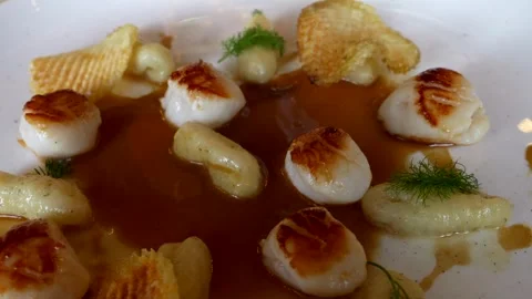 Super close up fennel gnocchi with cod fish morsels sauce. Video 4K Stock Footage 299803501