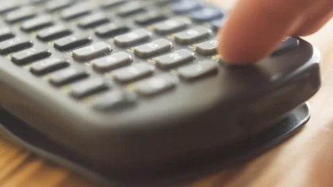 Super close up of hand using calculator Stock Footage 94015486
