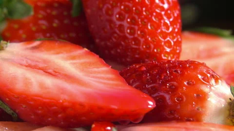 Super close-up of juice dropping on the halves of the red strawberry Stock Footage 136695467