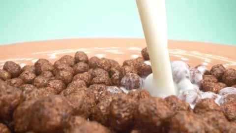 Super close up. milk is poured into breakfast cereals chocolate corn balls Stock Illustration