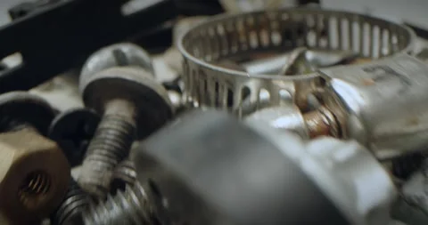 Super close. nut and bolt parts, fasteners in a heap. Stock Footage 310796190