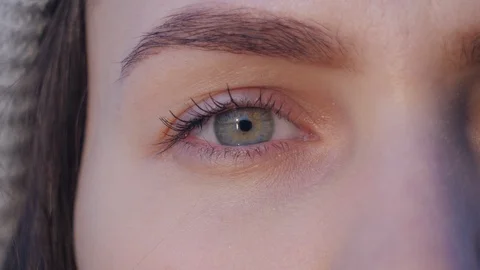 Super close up of a right green eye of young attractive woman which opens, looks Stock Footage 107170044