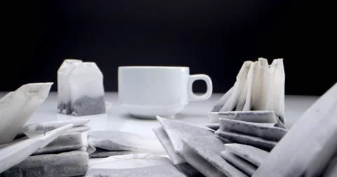Super close-up set of tea bags on a white table on a black background and a Stock Footage 160873946
