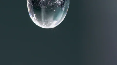 Super close-up slow motion video of a drop dripping from an icycle Stock Footage 92151501