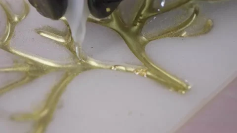 Super close up view hand carefully pour white consistency material on tree ar Stock Footage 157007398