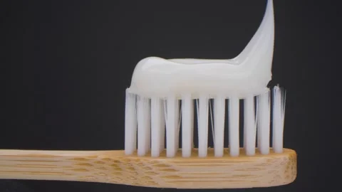 Super closeup view of toothpaste with bamboo toothbrush. Beautiful slider shot Stock Footage 155126080