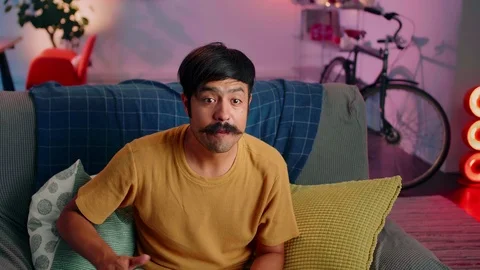 Super emotional Hispanic guy gesticulate watching sports match eating popcorn at Stock Footage 117131682