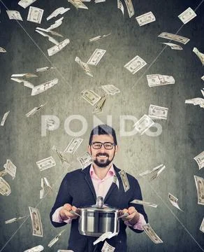 Super excited man with boil pan under money dollar bills rain Stock Photos