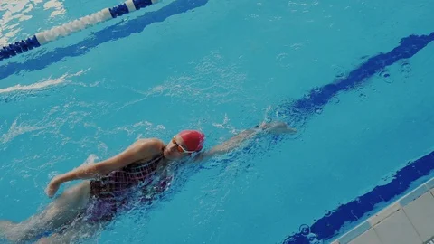 Super fast movement. View from above. A fit and strong woman swims on her back Stock Footage 112067828