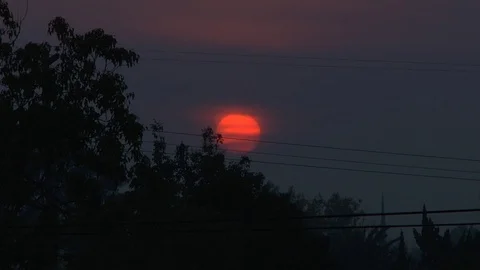 Super Fire Atomic Sunset Bright Red and Orange Smoke Filled Sky Sun Setting Stock Footage 101566067