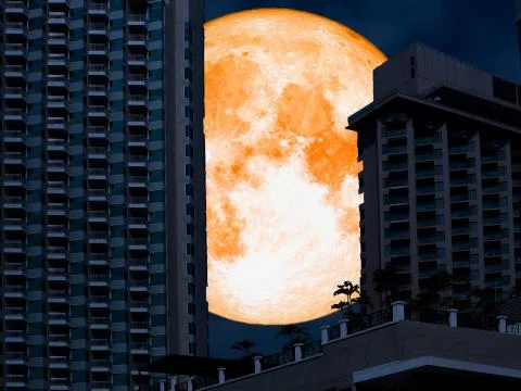 Super full orange moon back tower in night city 스톡 사진