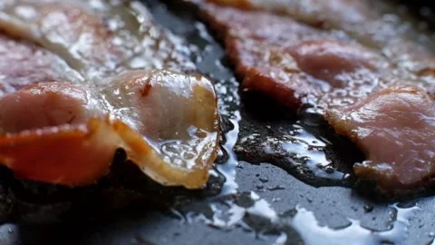 Super macro of bacon being fried in a pan. Stock Footage 88317012