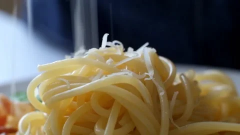 Super Macro - grated parmesan cheese falling on spaghetti Stock Footage 88317002
