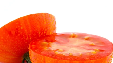 Super macro of half cut red globe striped tomato. Slowly rotating Stock Footage 95540806
