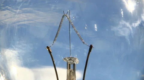 Super macro of light bulb stem with blue sky background Stock Footage 48118550