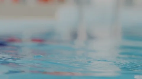 Super macro portrait. Young professional swimmer woman in red swim cap emerge Stock Footage 112065689