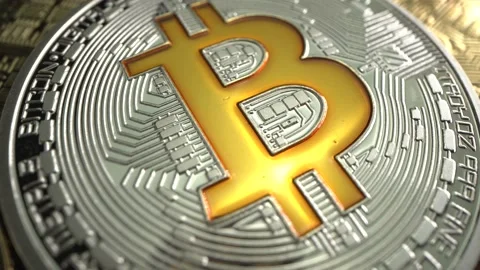 Super MACRO shot of Bitcoin BTC rotate on the table. Trading of gold coin before Stock Footage 129607495