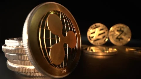 Super Macro shot. Gold crypto coin Ripple in the foreground and Zcash and Video stock 134522273