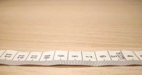 Super macro shot of a measuring tape into a roll of sewing and colored thread Stock Footage 168249280